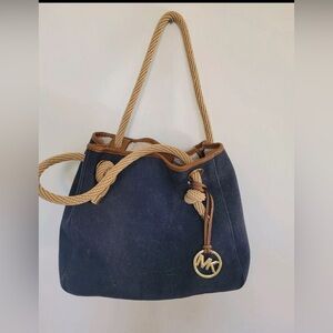 vintage Michael Kors handbag features a design that incorporates denim and rope.